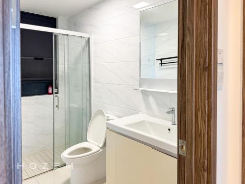 a white bathroom with a toilet and a sink at 3BR3B Hozem JB1306 Apartment Forest City in Gelang Patah