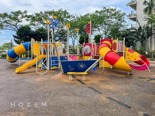 a row of colorful playground equipment in a park at 3BR3B Hozem JB1306 Apartment Forest City in Gelang Patah