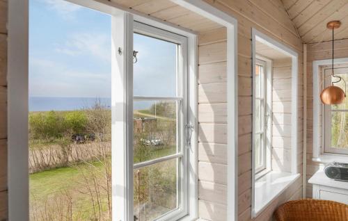 a room with a window with a view of the ocean at Nice Apartment In Dannemare With Sauna in Dannemare