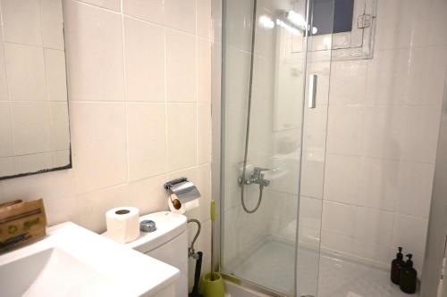 a bathroom with a shower and a toilet and a sink at Homenfun Barcelona Sants Estación in Barcelona