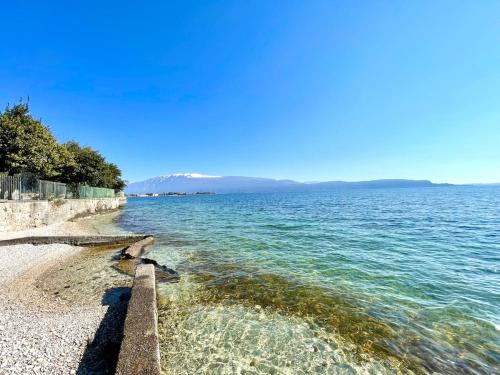 a view of the ocean from the shore at D1MORA LagoBlu - private beach and lake view in Toscolano Maderno