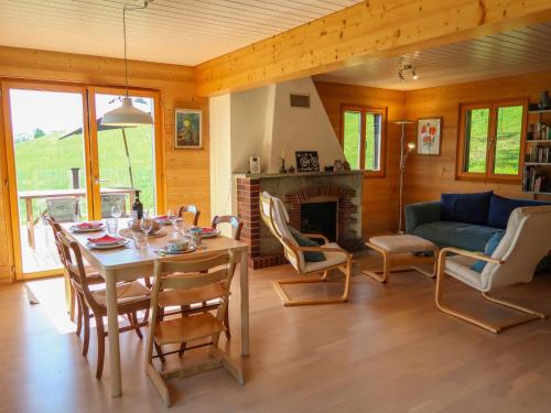 a living room with a table and chairs and a couch at Chalet Sozi by Interhome in Le Châtelard-Montreux