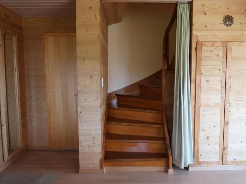 a staircase in a cabin with wooden walls at Chalet Sozi by Interhome in Le Châtelard-Montreux
