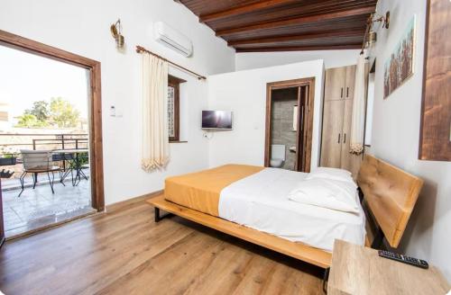 a bedroom with a large bed and a balcony at Caterina Cornaro House in Famagusta