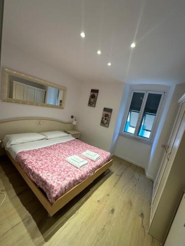 a bedroom with a bed and a window at Riomaggiore Appartamenti in Riomaggiore