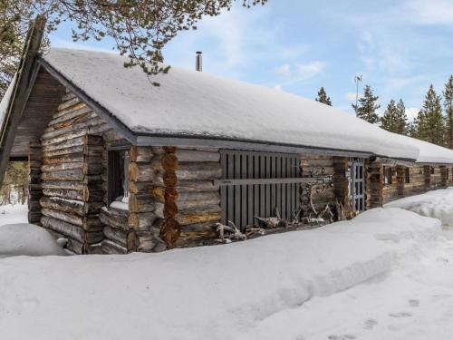 a log cabin with snow on the roof at Holiday Home Villa kopararova by Interhome in Saariselka