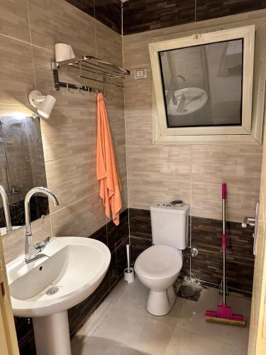 a bathroom with a white toilet and a sink at شاليه راس سدر Diamond resort in Ras Sedr