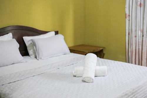 a bed with two rolls of paper towels on it at Senaru Gateway homestay in Senaru