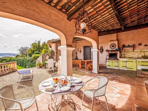 Il dispose d'une cuisine extérieure et d'un coin repas avec une table et des chaises. dans l'établissement Holiday Home Villa Philipp by Interhome, à Grimaud