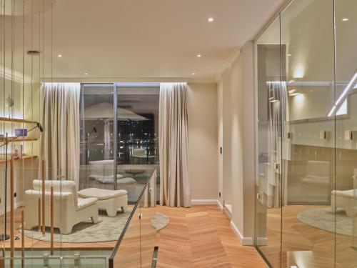 a living room with a glass staircase and a lobby at Seaside Villa by Brown Hotels in Trogir