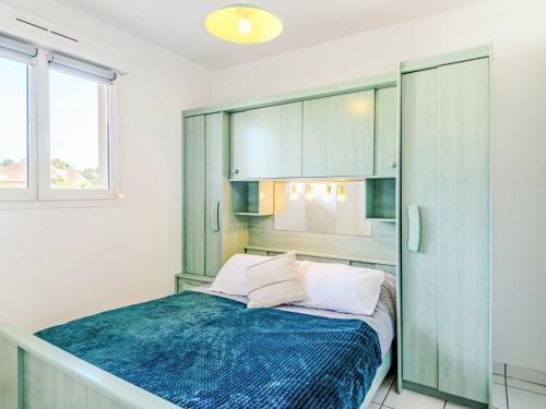 une chambre avec un lit avec une couverture bleue dans l'établissement Apartment Les Pêcheurs-7 by Interhome, à Mimizan