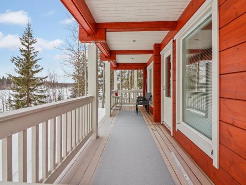 a front porch of a red house with a window at Holiday Home Huvila tornionjoen rannalla by Interhome in Pello