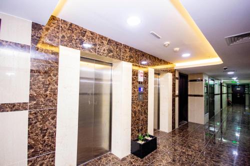 a lobby with a elevator in a building at Cozy Studio for Daily Rental Warsan in Dubai