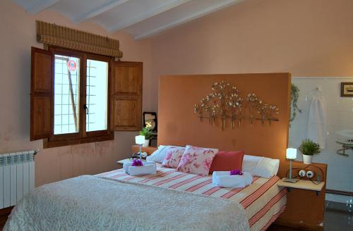 a bedroom with a large bed with pillows on it at Mas En Calma in Cabanes