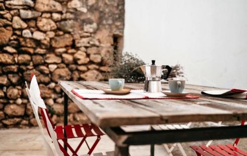 a wooden table with two cups of coffee on it at Palazzo Pati in Tiggiano