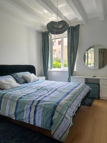 a bedroom with a bed and a large window at Apartment DB in Split