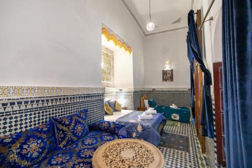 a living room with a bed and a couch at Riad Tarab Fes in Fès