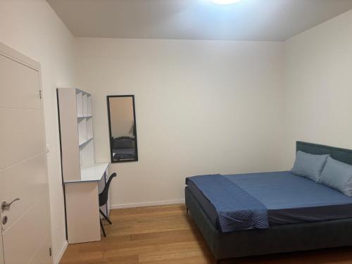 a small bedroom with a bed and a desk at Royal villa Nazareth in Nazareth