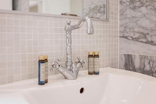 d'une baignoire avec un robinet et trois bouteilles. dans l'établissement 