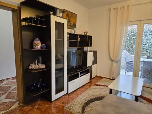 a living room with a black and white entertainment center at Apartment Anna in Polje