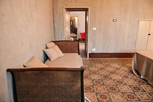 a couch with pillows on it in a room at Palazzo Pati in Tiggiano