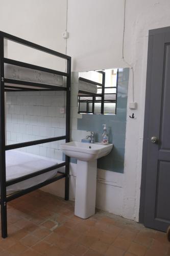 a bathroom with a sink and a bunk bed at Tumanyan Bathhouse Hostel in Tʼumanyan