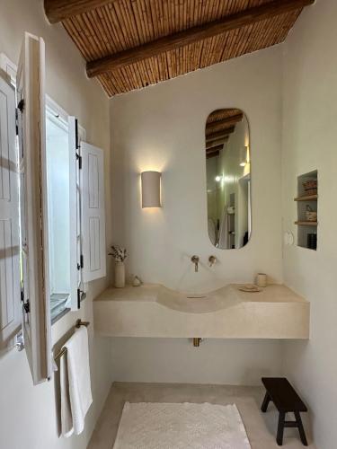 a bathroom with a sink and a mirror at Casa das Ameixas in Moncarapacho
