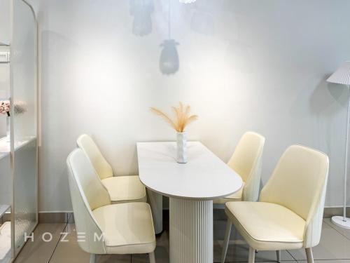 a white dining room with a white table and chairs at 2BR2B Hozem JB2502 Apartment Mount Austin in Johor Bahru