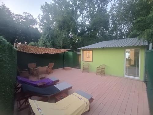 a patio with a table and chairs and a building at Green house in Sremska Kamenica