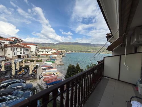 a balcony with a view of a harbor with boats at Villa Lucija in Ohrid