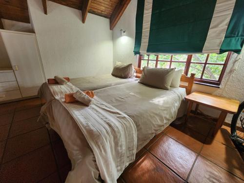 a bedroom with two beds and a window at Golf Estate Vacation Property - Poseidon's Knoll in White River