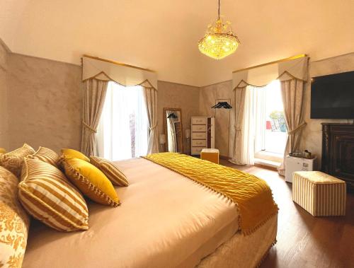 a bedroom with a large bed with yellow pillows at Suite-Regia Domus in Sovereto