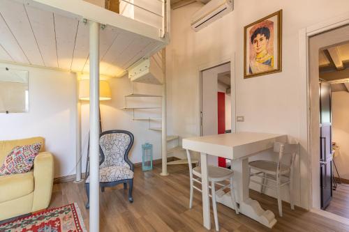 a room with a desk and a table in a tiny house at Podere Poggiolo in Trequanda