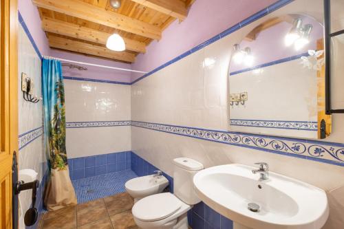 a bathroom with a white toilet and a sink at Cal Panxeta in Balsareny