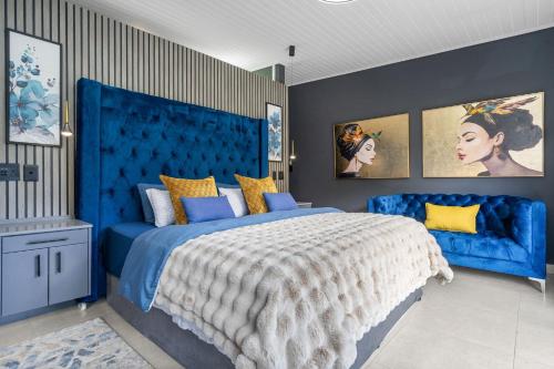 a blue bedroom with a large bed with a blue headboard at Red River Valley by Host Agents in Rooiels