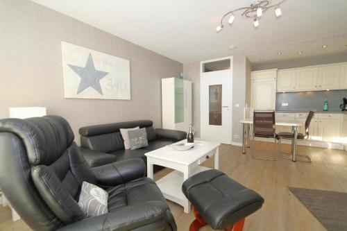 a living room with a couch and a table at Haus Käptn Christiansen 46 in Westerland