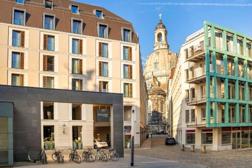 a group of buildings in a city with a clock tower at INNSiDE by Meliá Dresden in Dresden