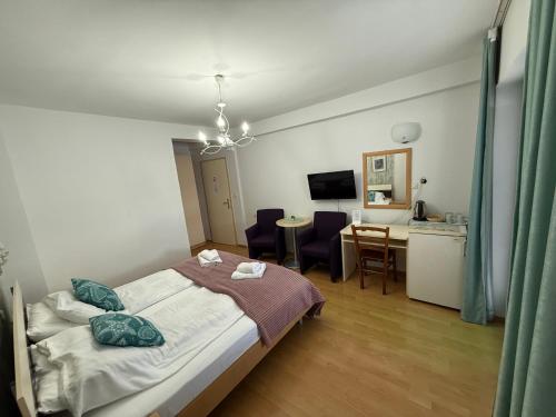 a bedroom with a bed and a table and chairs at Villa Lucija in Ohrid