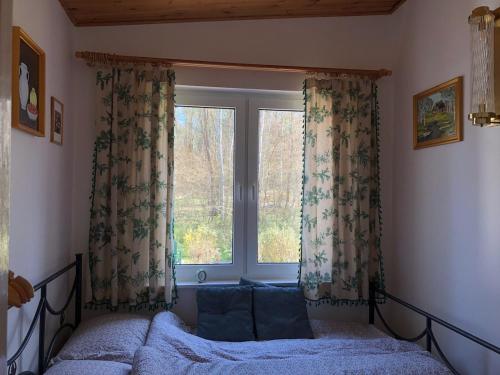 a bedroom with a bed and a window at Moja Stay - wyjątkowy dom z sauną in Niesulice