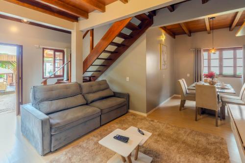 a living room with a couch and a table at Pousada Natribus Rosa in Praia do Rosa