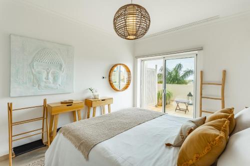 a bedroom with a bed and a desk and a window at Casa Eleonora lifestyle Lodge in Lagos