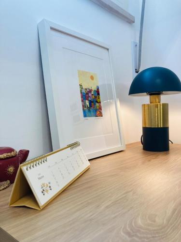 a desk with a computer keyboard and a lamp on it at City Garden Loft in Pescara
