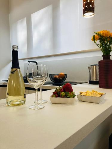 a table with a bottle of wine and a glass at City Garden Loft in Pescara