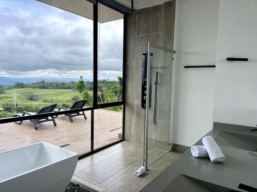 a bathroom with a shower and a sink and a view at New Espectacular Chalet de lujo con vistas de lujo in Quindío