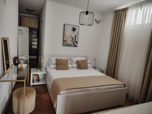 Postel nebo postele na pokoji v ubytování Apartments Ella