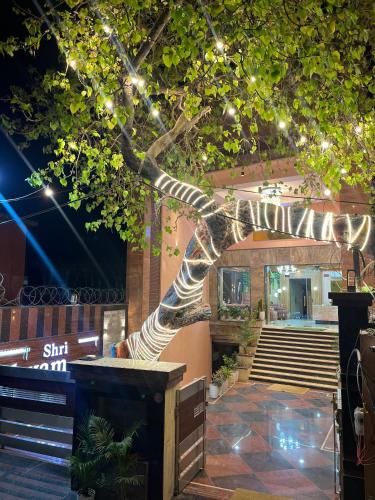 a statue of a tree with lights on it at Shri Shyam Hotel, Near Harkipauri in Haridwār