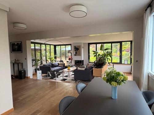 un salon avec une table et quelques chaises dans l'établissement Villa à Louveciennes, à Louveciennes