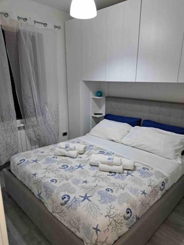 a bedroom with a large bed with towels on it at Antema in Scario