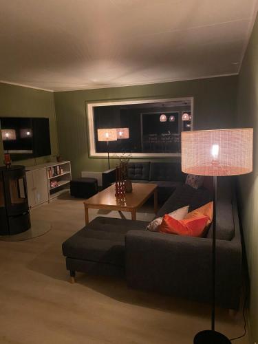 a living room with a couch and a table at Havblikk in Stø
