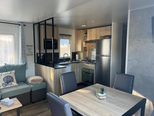 une cuisine et une salle à manger avec une table et des chaises dans l'établissement Coté Breizh, à Quiberon